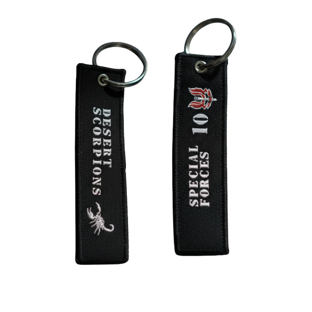 Double-sided tactical keyring showing the Desert Scorpions scorpion logo and Special Forces text on durable black cloth.