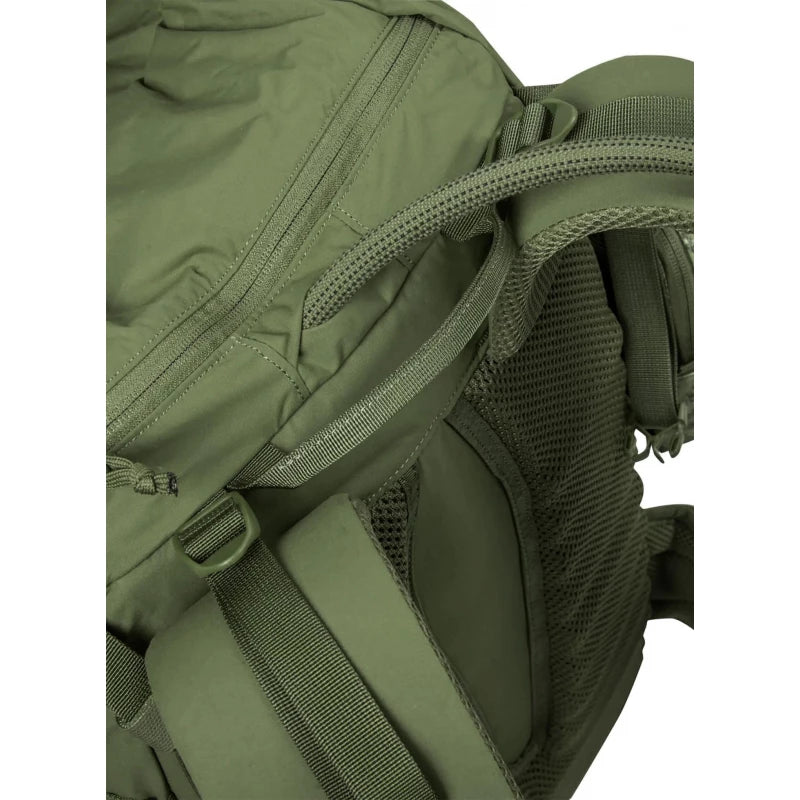 Close-up detail of an olive green tactical backpack showing the fabric texture, zipper pulls, mesh ventilation panels, and webbing straps.